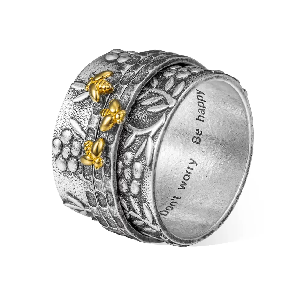 Silver ring with gold accents and engraved text on a white background